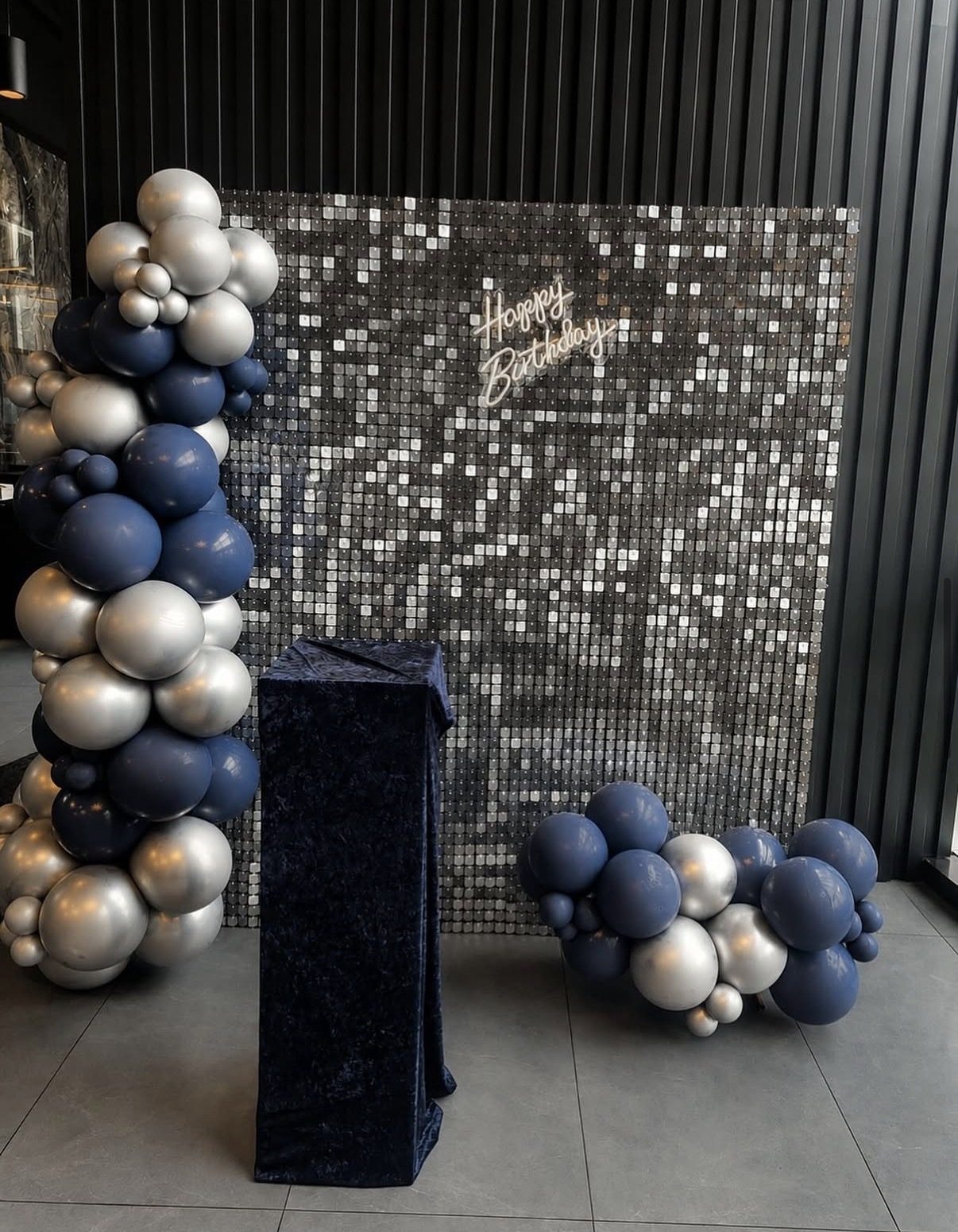 Silver sequin wall with navy and silver balloon garlands and neon Happy Birthday sign — birthday backdrop rental Vancouver