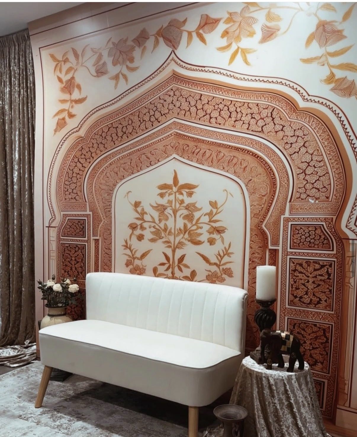 Jaipur arch backdrop with white loveseat — South Asian wedding decor rental in Surrey
